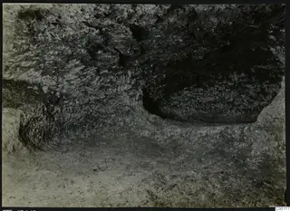Interior of rock-cut Tomb 315 a at Vrysi tou Barba, Lapithos, showing the chamber walls and floor.