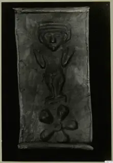 Rectangular metal plaque with an embossed standing figure and a lobed motif below, from Lapithos