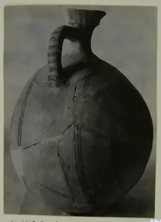 White Painted I jug from Lapithos, with a loop handle, tall neck and dark painted bands, mended cracks visible