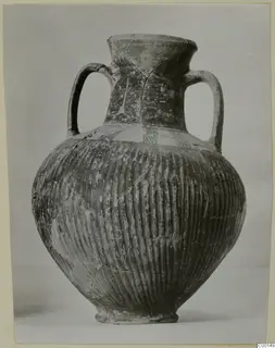Black slip painted amphora from the Lapithos Kastros tombs, with two handles and a ribbed body