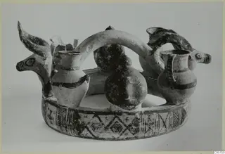 Pottery White Painted I - II from Lapithos: two animal heads with horns joined to painted jugs on a ring-shaped base.