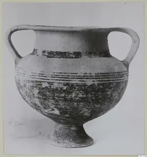 Two-handled White Painted I amphora with dark painted bands, seen from the side against a plain background