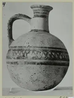 White Painted I jug from Lapithos with dark painted bands and a zigzag band around the body