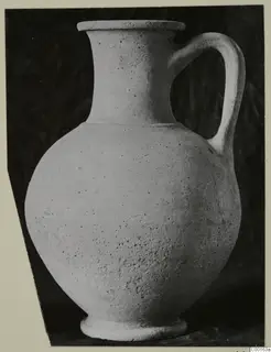 Plain pottery jug with a single loop handle, shown against a dark backdrop.
