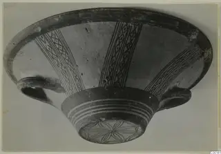 Pottery bowl from Lapithos with radiating diamond-lattice bands painted on the interior and a rosette on the base