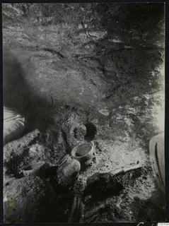 Tomb chamber at Lapithos, Vrysi tou Barba, with pottery vessels on the floor during excavation