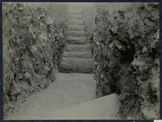 Stone steps rising between earthen cut walls during excavation at Soli theatre