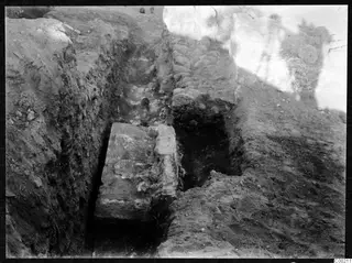 Excavation trench at the theatre at Soli, with a large stone block and a rubble wall.