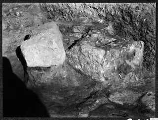 Excavated stone blocks in a trench at Soli, with earth walls rising behind them.