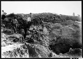 Excavation at the theatre at Soli, with workers beside stone substructure walls of the east eisodos.
