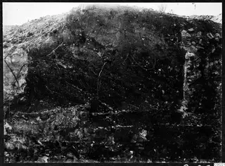 Excavated soil face with roots and stone courses at the theatre at Soli
