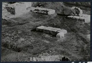Excavated area of the theatre at Soli with rows of cut stone blocks set in the ground