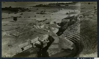 Excavated theatre at Soli with curved tiers of stone seating on the right and stone blocks in the foreground