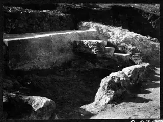 Stone steps uncovered during excavation at the theatre at Soli, with rocks and dug earth around them.