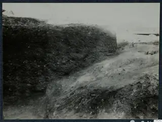 Excavated soil section and sloping trench at the theatre at Soli, with a hillside in the background
