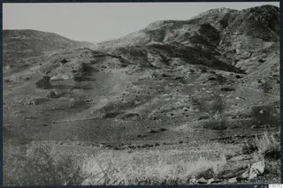 Dry, scrubby hills at Soli with rocky slopes and sparse shrubs under a pale sky
