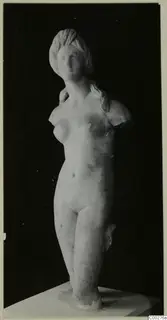 Nude marble statue, probably of Aphrodite, standing on a square plinth with both arms broken off