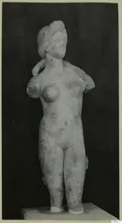 Marble statue of a female nude, probably representing Aphrodite, with the arms broken off, standing on a plinth