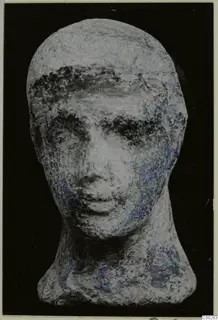 Terracotta Minor Plastic 2, a head figurine with a neck, seen from the front against a black background