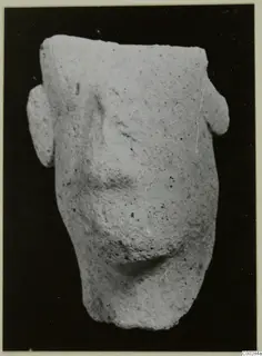 Terracotta figurine fragment from Soli with two side projections, photographed on a black background
