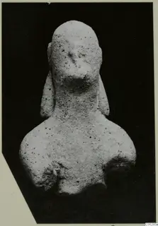 Terracotta figurine of a head and shoulders, with hair falling in long locks beside the neck