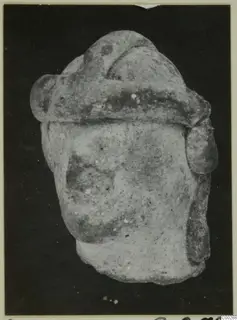 Terracotta figurine fragment from Soli with a broad band across the top, shown against a dark background.