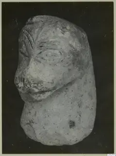 Terracotta figurine of a head with a projecting nose and mouth on a short rounded body, from Soli.