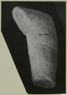 Marble sculpture fragment, a rounded stone piece with an angled upper block and a crack across its middle