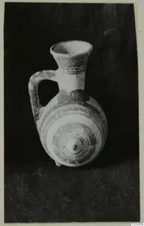 Pottery Bichrome II juglet with a flared neck, one loop handle and painted concentric rings on the body