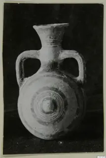 Pottery Bichrome II flask with two loop handles and concentric circles on its flattened front, from Lapithos.