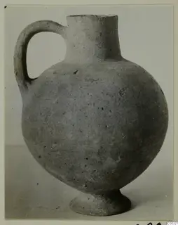 Plain pale jug with a single handle, tall neck and ring foot, from Lapithos