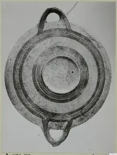 White Painted I bowl with two loop handles, photographed from above