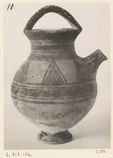 White Painted I jug with a strap handle, side spout and painted bands and triangles