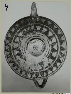 Round painted clay object with dark triangle bands, seen from above, from the Kastros tombs at Lapithos