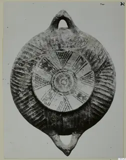 Black Slip Bichrome oil lamp from the Kastros tombs at Lapithos, with a loop handle at top and bottom
