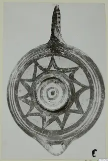 Pottery lamp with a long nozzle and star-shaped painted bands on its disc, from Lapithos Kastros tombs