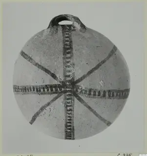 White Painted I bowl (L.420.27), a round vessel with a loop handle and dark painted bands radiating from the centre of the body