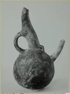 Red Polished III jug from Lapithos, with a side spout, loop handle and incised diamond pattern