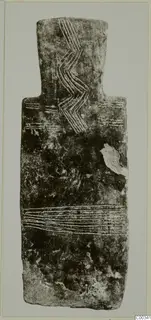 Back of a plank-shaped idol from Lapithos, with incised zigzag and horizontal lines on a dark, worn surface