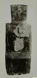 Idol with a tall narrow neck and pale bands on a dark surface, from the Vrysi tou Barba tombs at Lapithos