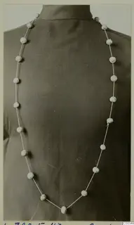 Necklace of pale round beads on a thin cord, from the Vrysi tou Barba tombs at Lapithos