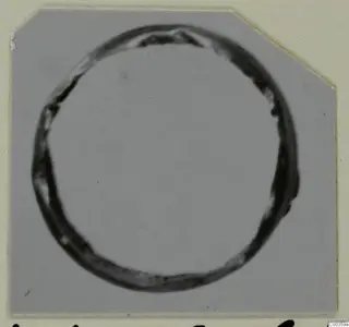 Gold ring from the Kastros tombs at Lapithos, seen from above on a grey card mount