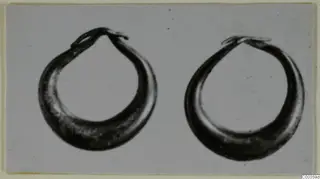 Two gold hoop rings from Lapithos shown side by side against a plain background