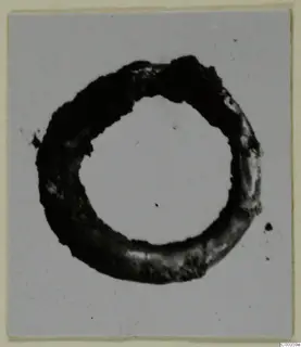 Gold ring from the Kastros tombs at Lapithos, photographed alone on a light background