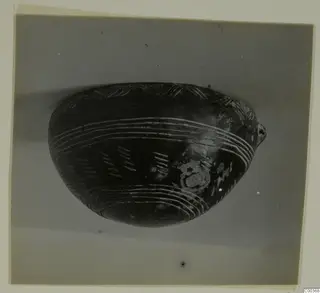 Black Polished bowl with pale grooved bands and hatched marks on its side