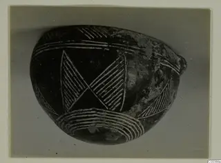 Dark polished bowl from Lapithos with incised hatched triangles and bands of lines.