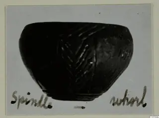 Black polished bowl with incised chevron bands, from Lapithos, on a grey card mount