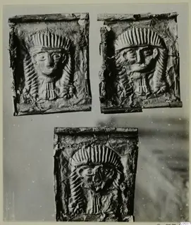 Three embossed metal plaques showing frontal faces framed by radiating headdresses, from Lapithos Kastros