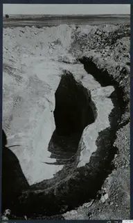 Dromos leading down to the entrance of Tomb 12 at Milia, cut into pale earth