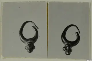 Two photographs of the same gold earring with an open loop and a cluster of small round beads at its base.